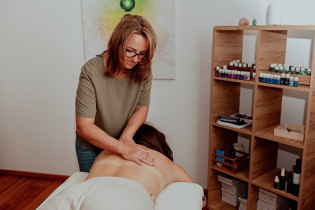 a woman massaging a woman's back